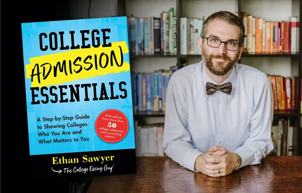 A man with glasses and a bow tie sits at a table in front of bookshelves next to the cover of a book titled "College Admission Essentials" by Ethan Sawyer.