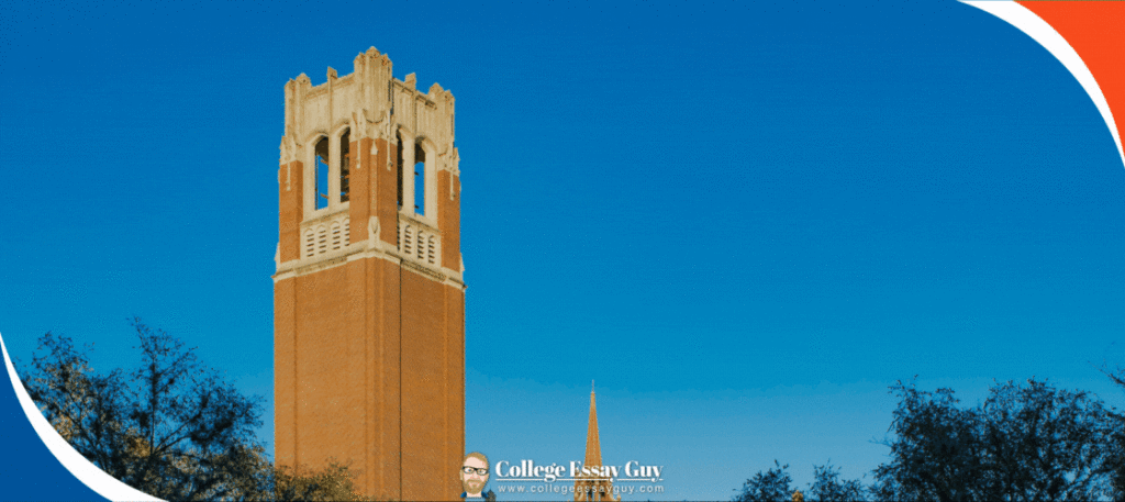 Brick bell tower with white accents rises above trees against a clear blue sky, with a "College Essay Guy" logo at the bottom center of the image.