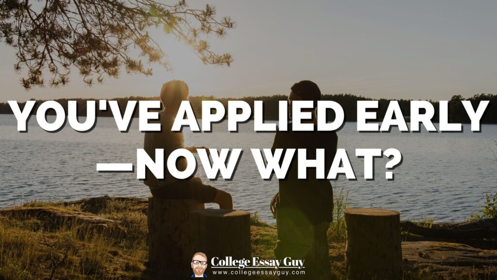 Two people sit on tree stumps by a lake at sunset with the text, "YOU'VE APPLIED EARLY — NOW WHAT?" displayed in large letters.