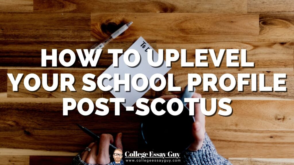 A person holding a pen and a cup sits at a wooden table with a notepad; text overlay reads, "How to Uplevel Your School Profile Post-SCOTUS.