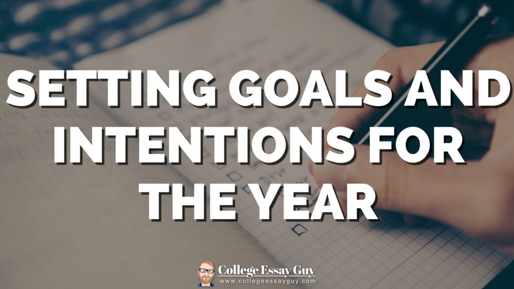 A hand writes in a notebook with checkboxes, overlaid with the text "Setting goals and intentions for the year.